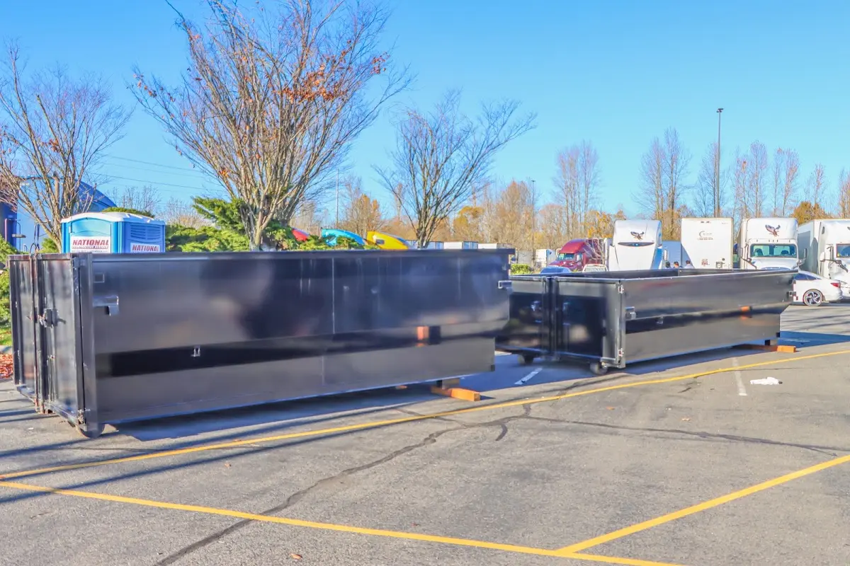 Professional dumpster rental service with roll-off container on residential driveway in Commerce City